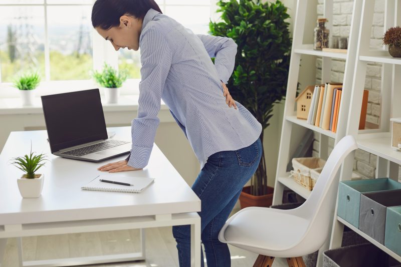 Backache.,Woman,Suffering,From,Back,Pain,At,Workplace.
